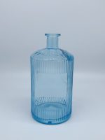 Blue painted bottle with embossed ribbons