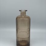 Brown painted bottle with embossed ribbons